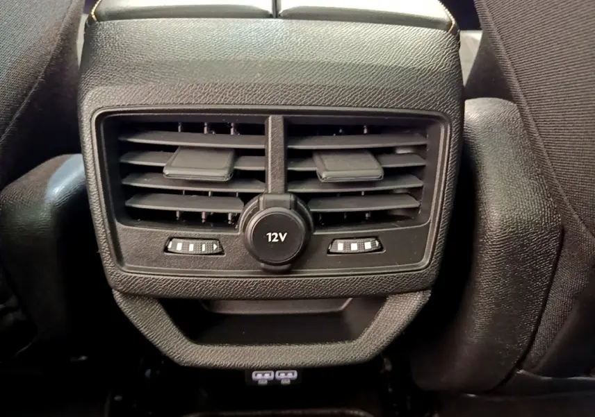 Vue rapprochée des aérateurs arrière noirs avec prise 12V et commandes de ventilation du Peugeot 3008 GT rouge 2021.