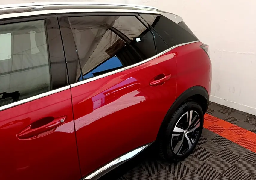 Vue côté droit arrière du Peugeot 3008 GT rouge avec jante alliage et contour de vitre chromé.