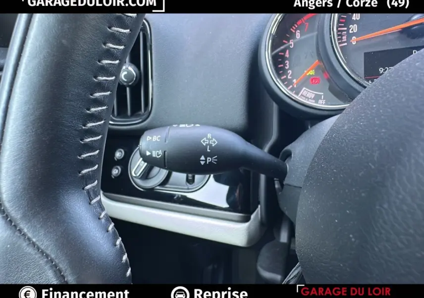 Gros plan sur le commodo de clignotant à gauche du volant cuir noir du tableau de bord MINI Countryman bleu 2020.