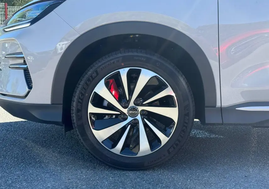 Gros plan sur la roue avant gauche du BYD SEAL U 1.5 DM-i 218ch Boost en Boundless Cloud métallisé avec jante alu bicolore.