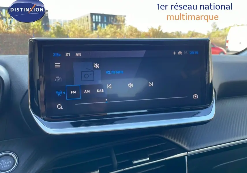 Écran tactile central du tableau de bord de la Peugeot 208 Hybrid 110ch Allure, affichant la radio FM.