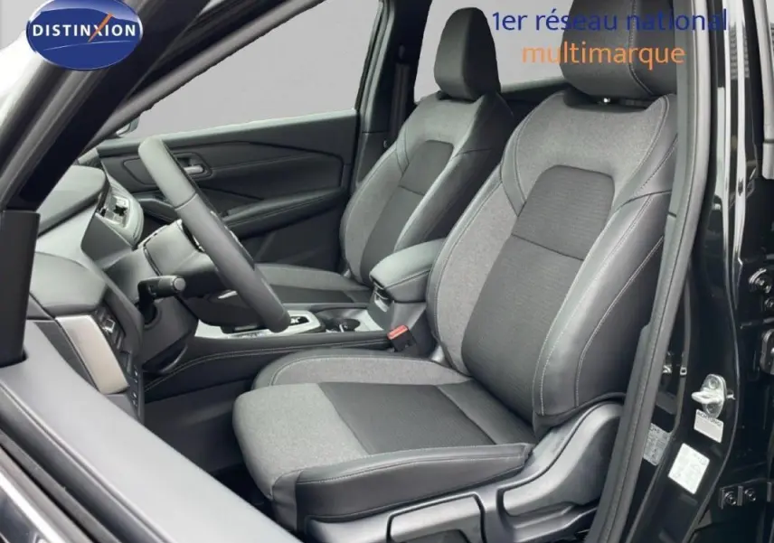 Vue intérieure côté conducteur du Nissan Qashqai noir 2025, mettant en valeur les sièges en tissu bicolore et le tableau de bord moderne.