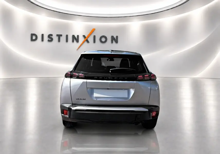 Vue arrière d'un Peugeot 2008 gris 2025 dans un showroom avec logo Distinxion en fond.