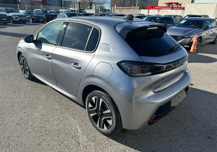Peugeot 208 Hybrid gris vue 3/4 arrière droit, jantes alliage 16 pouces et vitres teintées.