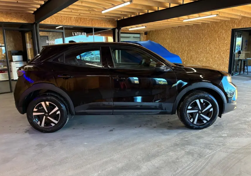 Opel Mokka 1.2 Turbo 145 Edition noir vue de profil côté gauche, avec jantes alliage et intérieur tissu noir visible.