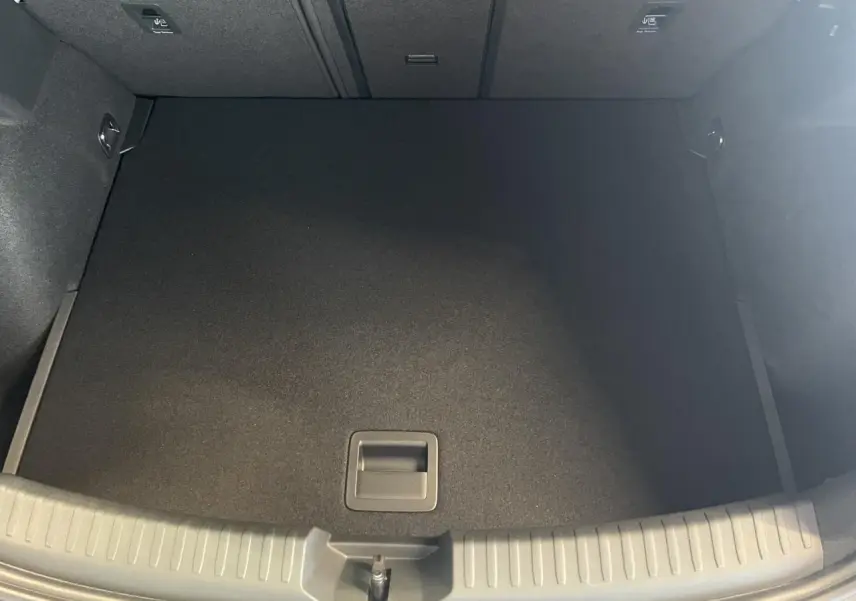 Coffre ouvert vu de dessus de la CUPRA Leon gris, montrant un espace de chargement vide et propre.