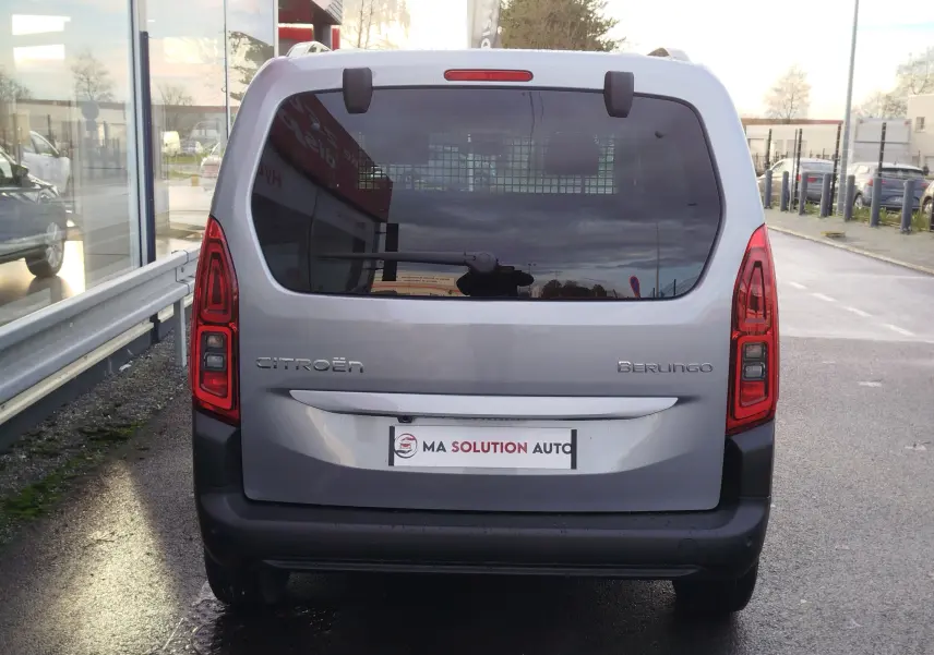 Vue arrière d’un Citroën Berlingo gris acier 2026 avec feux arrière verticaux et vitre arrière teintée.