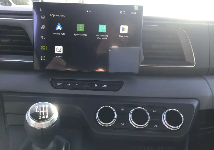 Vue intérieure du tableau de bord du Renault Master blanc 2025, avec écran tactile 10'' et levier de vitesses manuel visible.