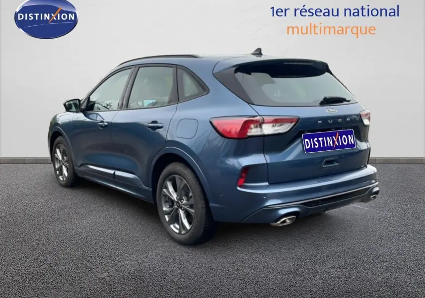 Vue 3/4 arrière droite d’un Ford Kuga bleu Vapor Metal 2024 avec finition ST-LINE et double sortie d’échappement chromée.