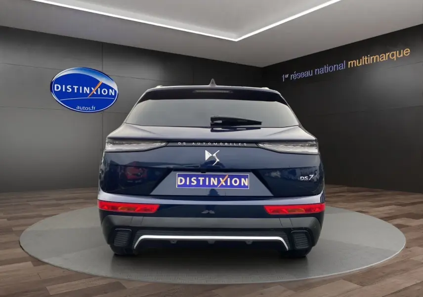 Vue arrière d'un DS7 Bleu Eclipse 2024, soulignant ses feux fins et son logo DS centré sur le hayon.