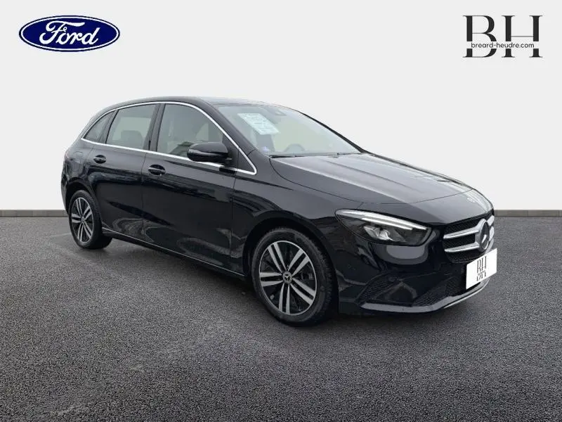 Vue 3/4 avant gauche d'une Mercedes Classe B 250 e noire cosmos métallisé avec jantes alu et phares LED.