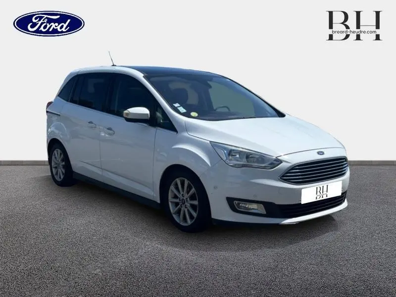 Ford Grand C-Max blanc Glacier vue 3/4 avant droit avec toit panoramique et vitres arrière teintées.
