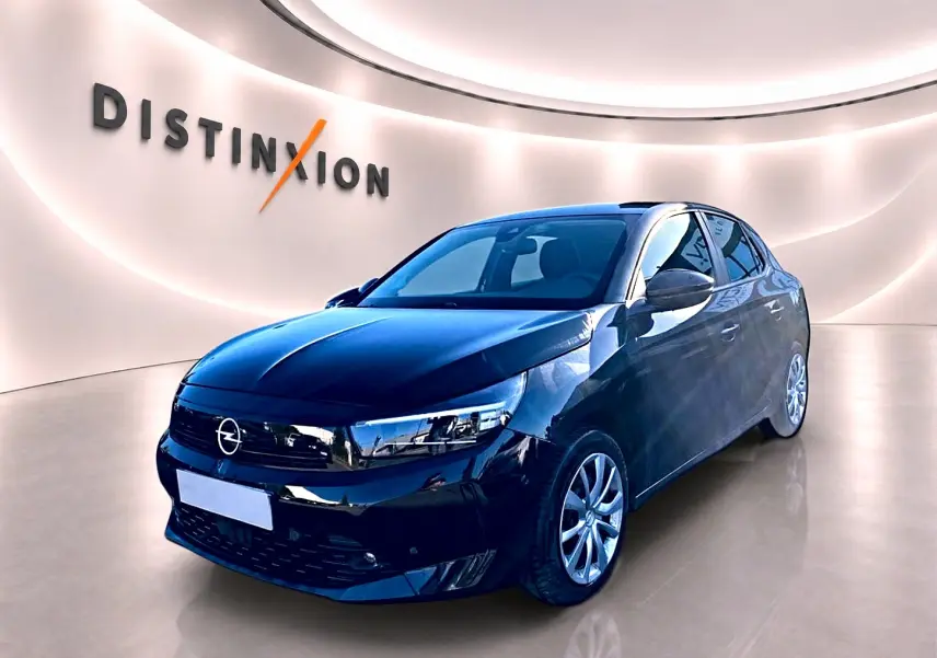 Opel Corsa noire vue 3/4 avant droit dans un showroom lumineux avec logo Distinxion en arrière-plan.