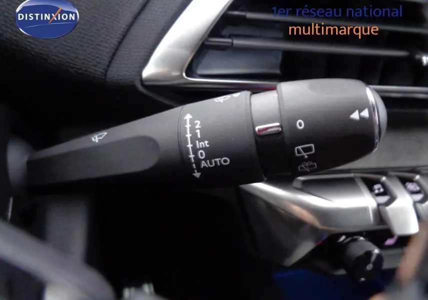 Gros plan sur la commande d’essuie-glace dans l’habitacle du Peugeot 3008 noir perle métal, côté gauche du volant.