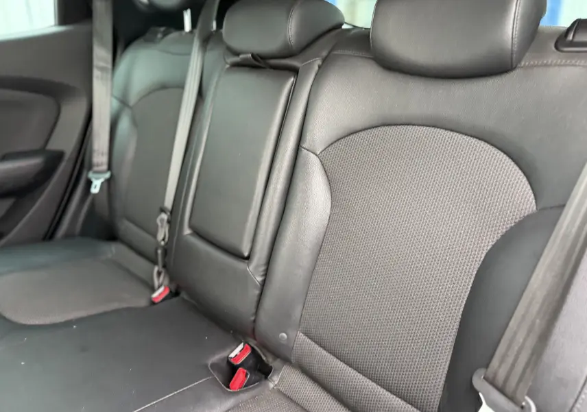 Vue rapprochée des sièges arrière en cuir noir du Hyundai ix35 2014, avec ceintures de sécurité visibles.