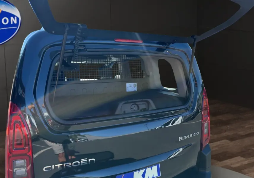 Vue arrière du Citroën Berlingo noir 2026 avec hayon ouvert, montrant l’intérieur utilitaire et la grille de séparation.