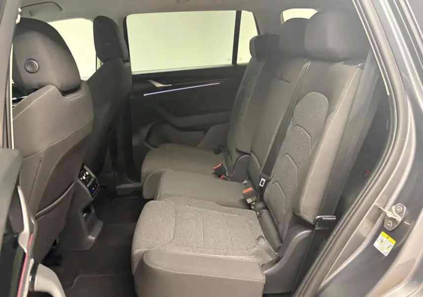 Vue intérieure côté droit des sièges arrière en tissu gris du Skoda Kodiaq 2025 gris graphite, version 7 places.