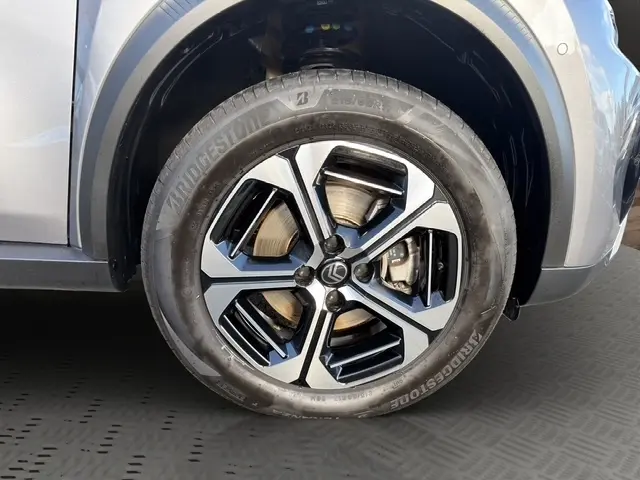Gros plan sur la roue avant droite gris foncé de la Citroën C3 Aircross hybride 2025 avec jante alliage noire et argentée.