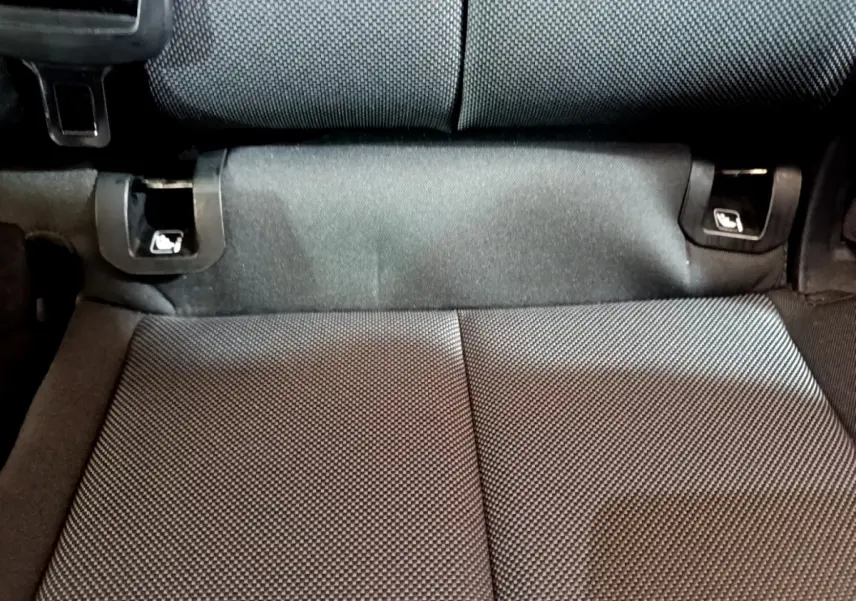 Détail de la banquette arrière noire de l'Audi Q3 35 TDI 150 S tronic Business Line, vue rapprochée du tissu et des fixations Isofix.