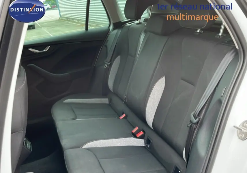 Vue intérieure côté droit des sièges arrière en tissu gris noir de la Skoda Scala blanc glacier 2025.