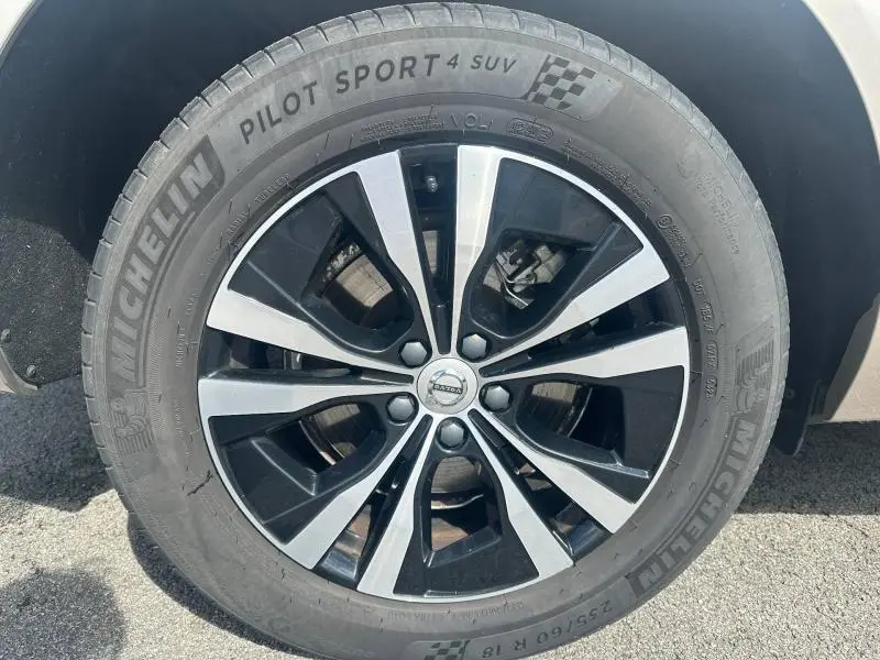 Gros plan sur la jante alu bicolore noire et argentée du Volvo XC60 gris, avec pneu Michelin Pilot Sport 4 SUV.