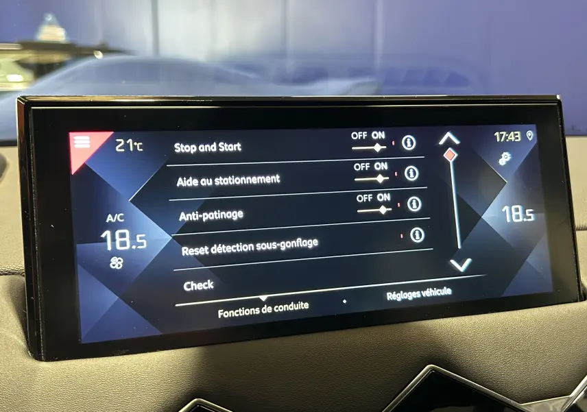 Écran tactile central du DS3 Crossback Bleu Millenium affichant les réglages d’aide à la conduite et climatisation à 18,5°C.