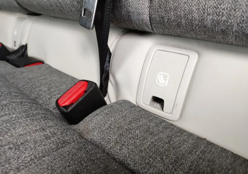 Gros plan sur l’ancrage ISOFIX et les ceintures rouges sur la banquette arrière grise du Mazda MX-30 électrique 2023.
