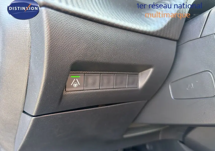 Bouton d'assistance au maintien de voie sur tableau de bord noir du Peugeot 2008 hybride 2026, vue intérieure côté conducteur.
