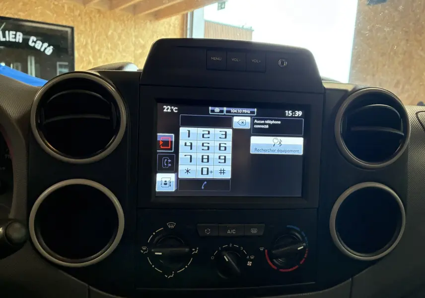 Vue rapprochée du tableau de bord noir du Citroën Berlingo 2016 avec écran tactile et commandes de climatisation.