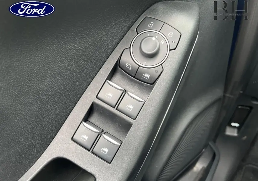 Vue rapprochée des commandes de lève-vitres et réglages des rétroviseurs côté conducteur du Ford Puma 2023.