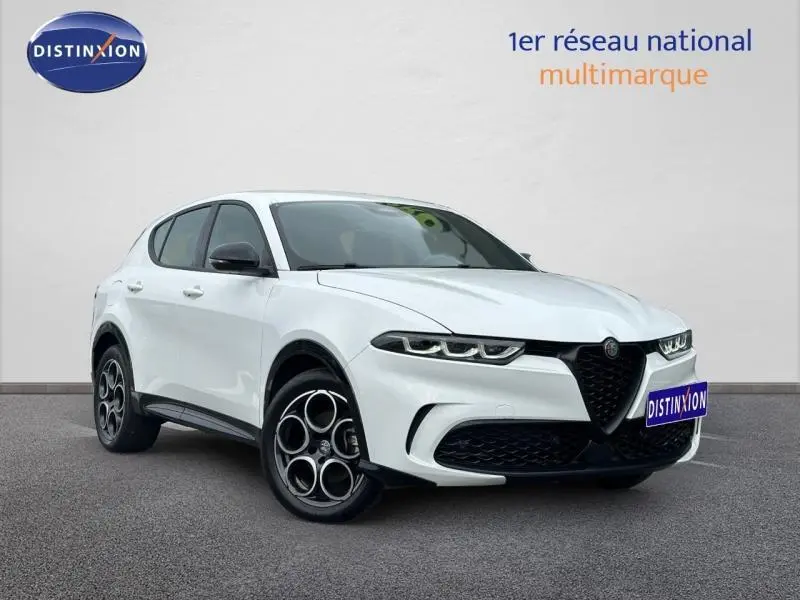 Vue 3/4 avant droite de l'Alfa Romeo Tonale blanc Monterosa avec jantes alu distinctives et calandre noire.