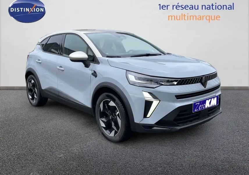 Renault Captur E-Tech hybride 2025 gris Rafale en 3/4 avant droit avec toit beige et jantes noires.