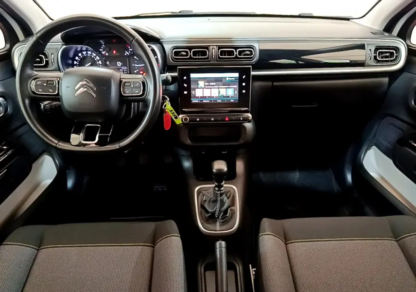 Intérieur de la Citroën C3 PureTech 110 2019 vu de face, tableau de bord noir avec écran tactile central et volant cuir.