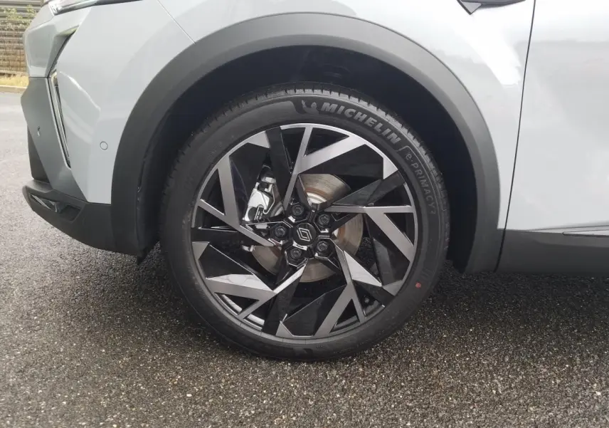 Gros plan sur la roue avant gauche du Renault Captur gris Rafale 2025 avec jante alliage 19 pouces au design géométrique.