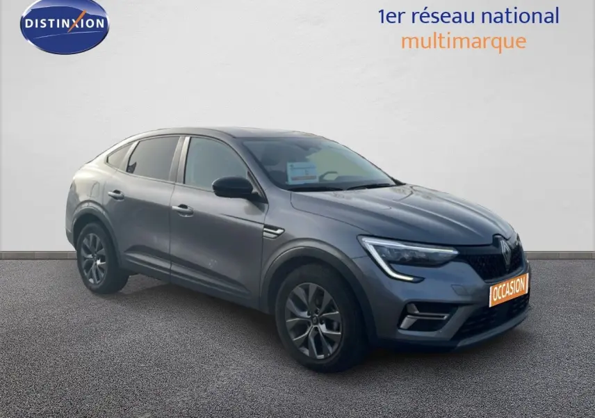 Vue 3/4 avant droit d'une Renault Arkana gris satin métal, SUV compact avec feux LED et jantes alliage.