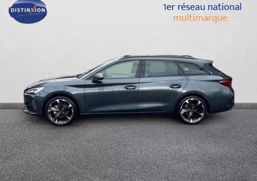 Vue de profil côté gauche d'une CUPRA Leon ST gris 2024 avec jantes aluminium et toit ouvrant panoramique.