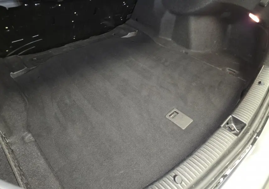 Vue plongeante sur le coffre noir propre d'une Mercedes Classe C 200 d Business gris, sans chargement visible.