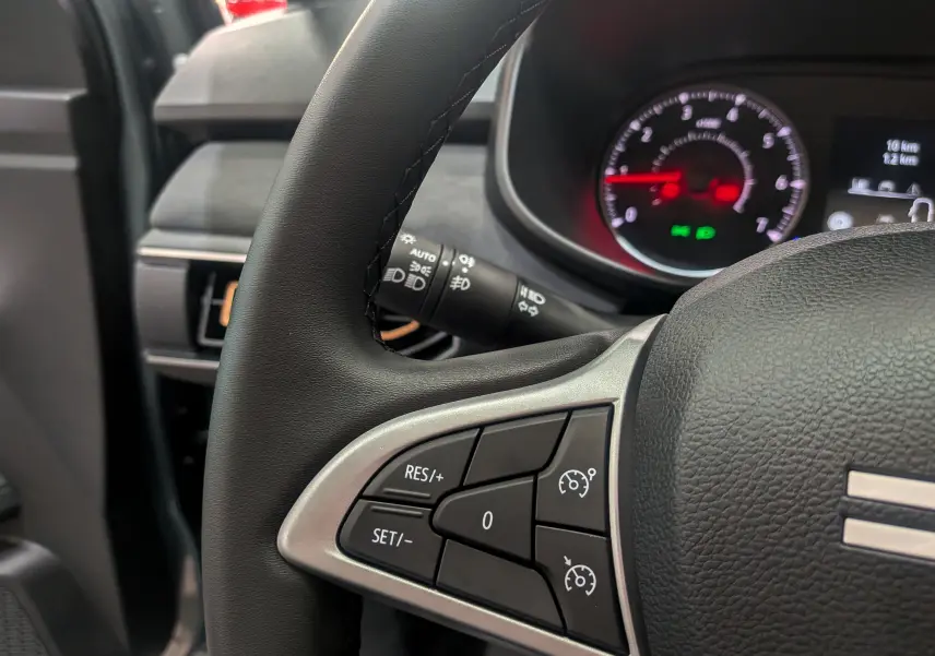 Gros plan sur le volant à gauche du Dacia Sandero Stepway 2025, montrant les commandes de régulateur de vitesse.