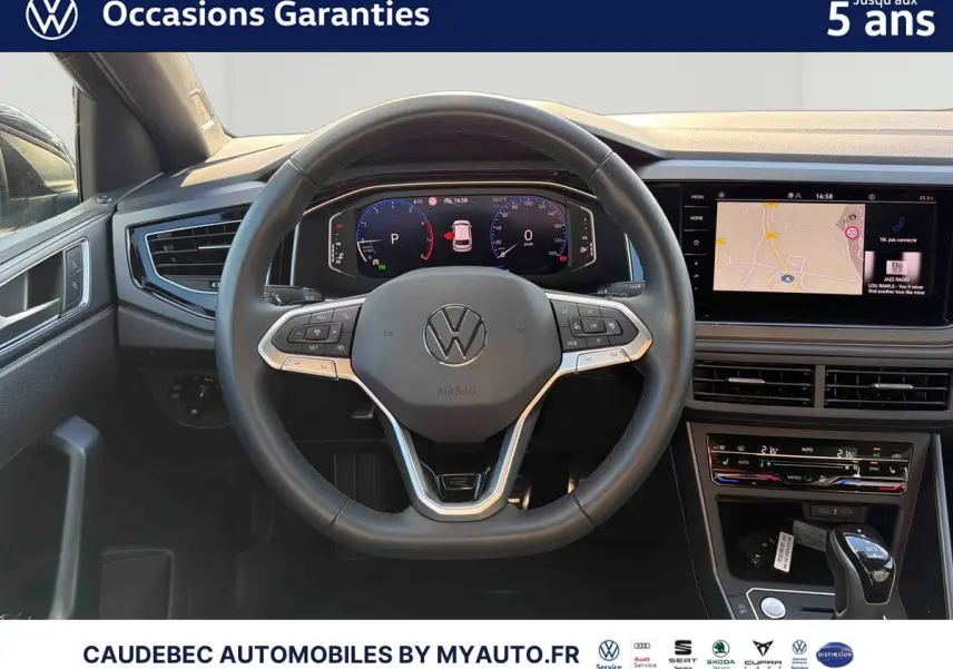 Vue intérieure centrée sur le volant cuir multifonctions et le tableau de bord digital de la Volkswagen Polo noire.
