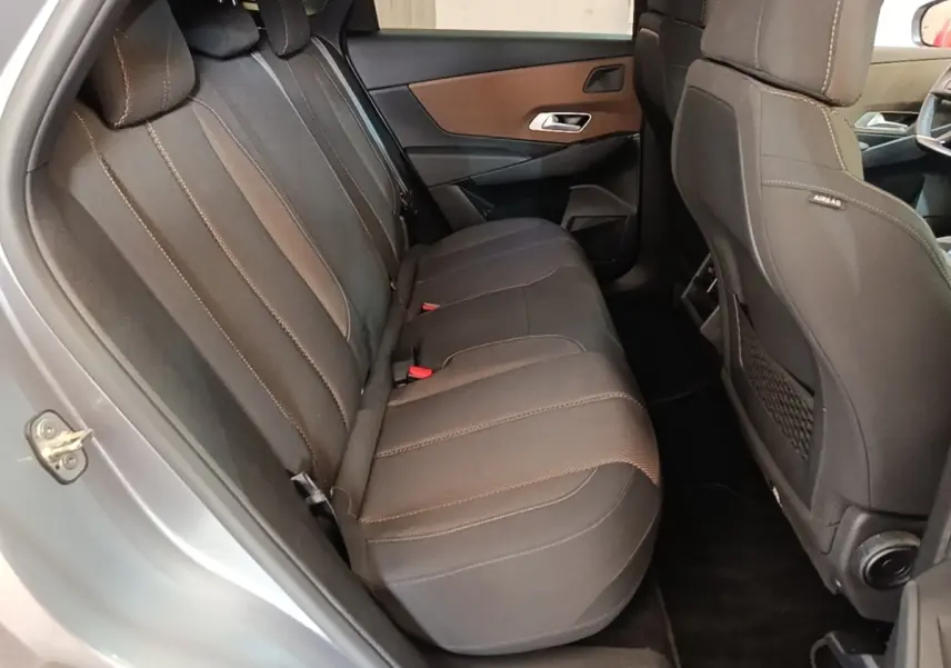 Vue intérieure côté gauche montrant la banquette arrière noire du DS7 Crossback E-TENSE 225 BUSINESS gris foncé.