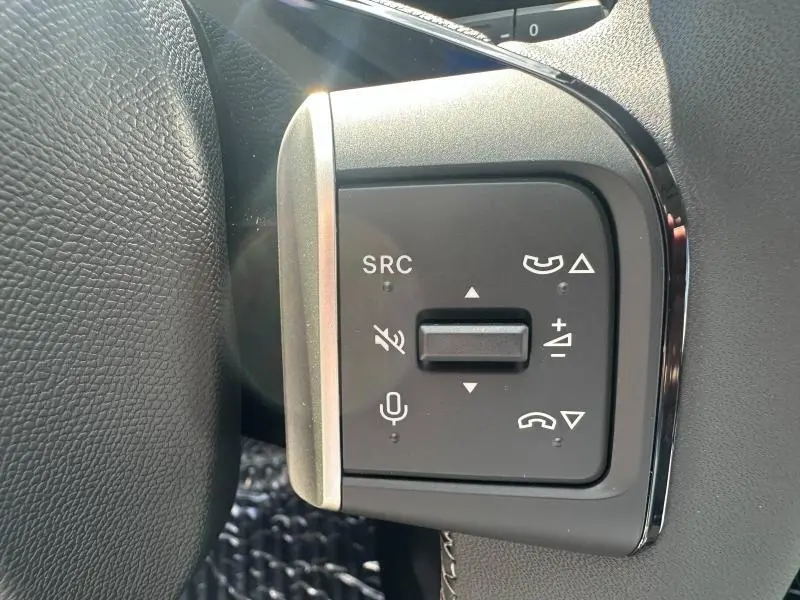 Gros plan sur les commandes vocales et téléphoniques au volant du Citroën C3 Aircross gris Mercury.