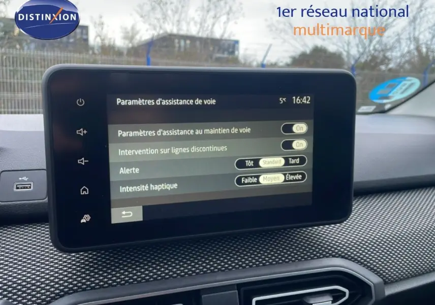 Vue intérieure du tableau de bord du Dacia Jogger 2025, écran tactile affichant les paramètres d'assistance de voie.