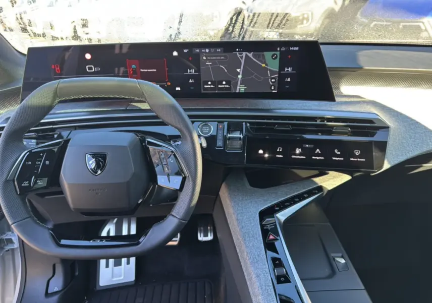 Vue intérieure du tableau de bord et volant cuir noir du Peugeot 3008 New Hybrid 145 GT 360 de 2025.