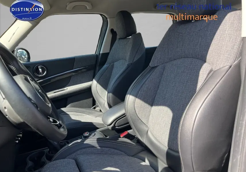 Vue intérieure côté conducteur du MINI Countryman 2019, sièges sport gris avec cuir noir et accoudoir central.