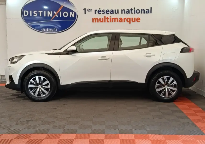 Peugeot 2008 blanc vue de profil côté gauche, SUV compact avec jantes alliage et toit noir contrasté.