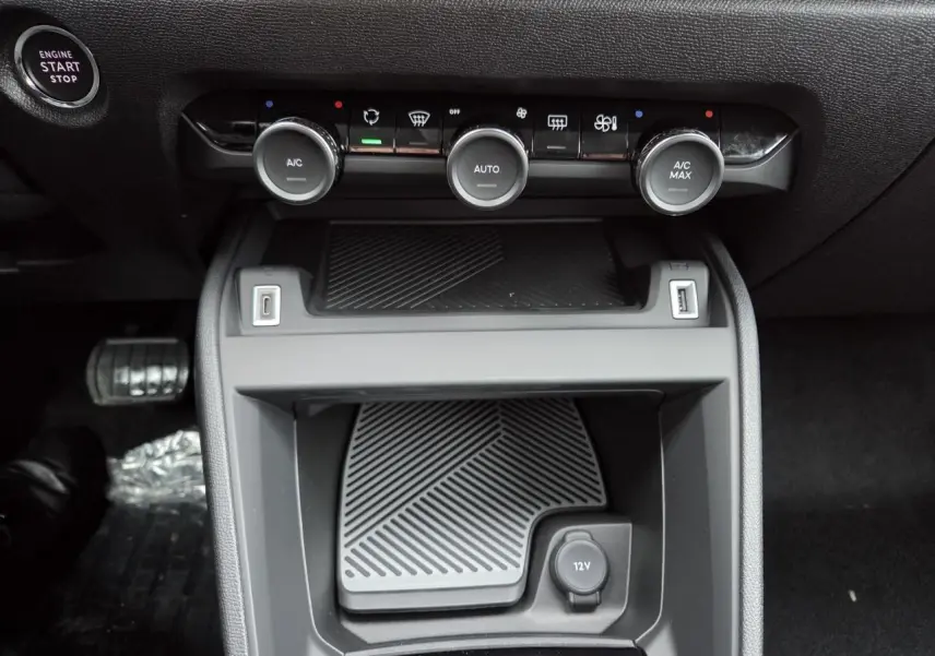 Vue rapprochée de la console centrale noire avec commandes climatisation et prise 12V de la Citroën C4 blanche toit noir