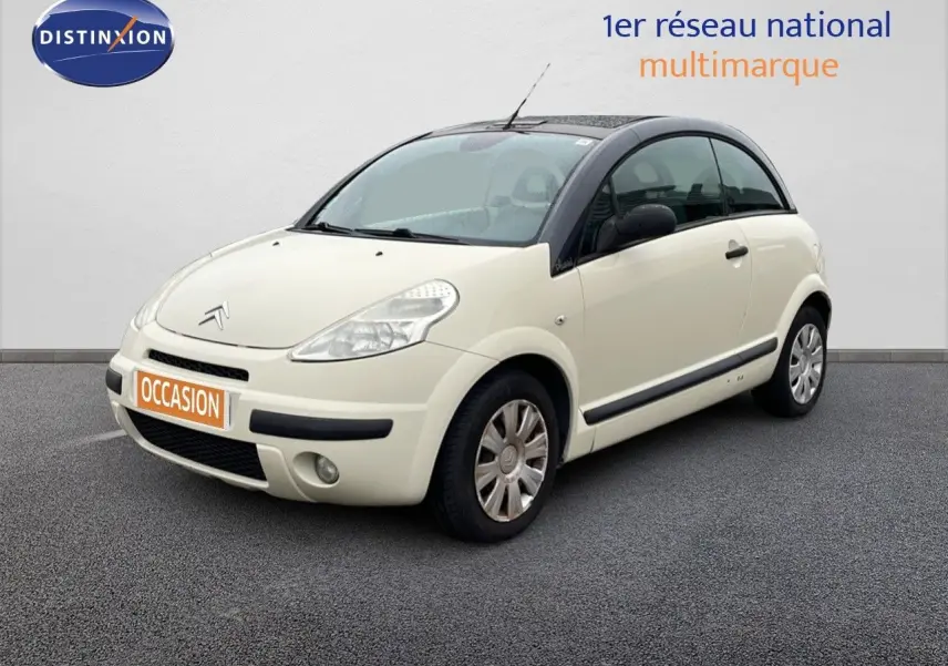 Citroën C3 Pluriel ivoire vue 3/4 avant droit avec toit noir et jantes acier d'origine.