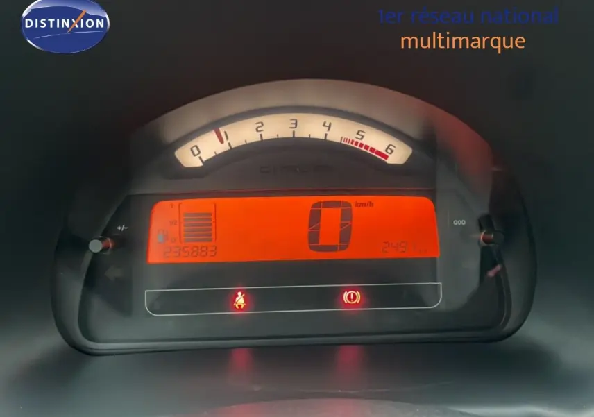 Tableau de bord numérique de Citroën C3 Pluriel 2007 avec affichage orange du compteur et compte-tours analogique.