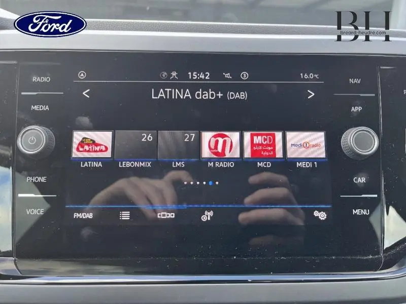 Écran tactile multimédia de Volkswagen Polo 2022 affichant la radio DAB+ avec commandes autour en noir brillant.