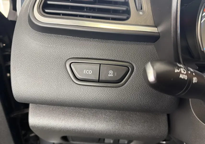 Détail intérieur du tableau de bord côté gauche du Renault Kadjar gris, avec boutons ECO et arrêt auto start-stop.